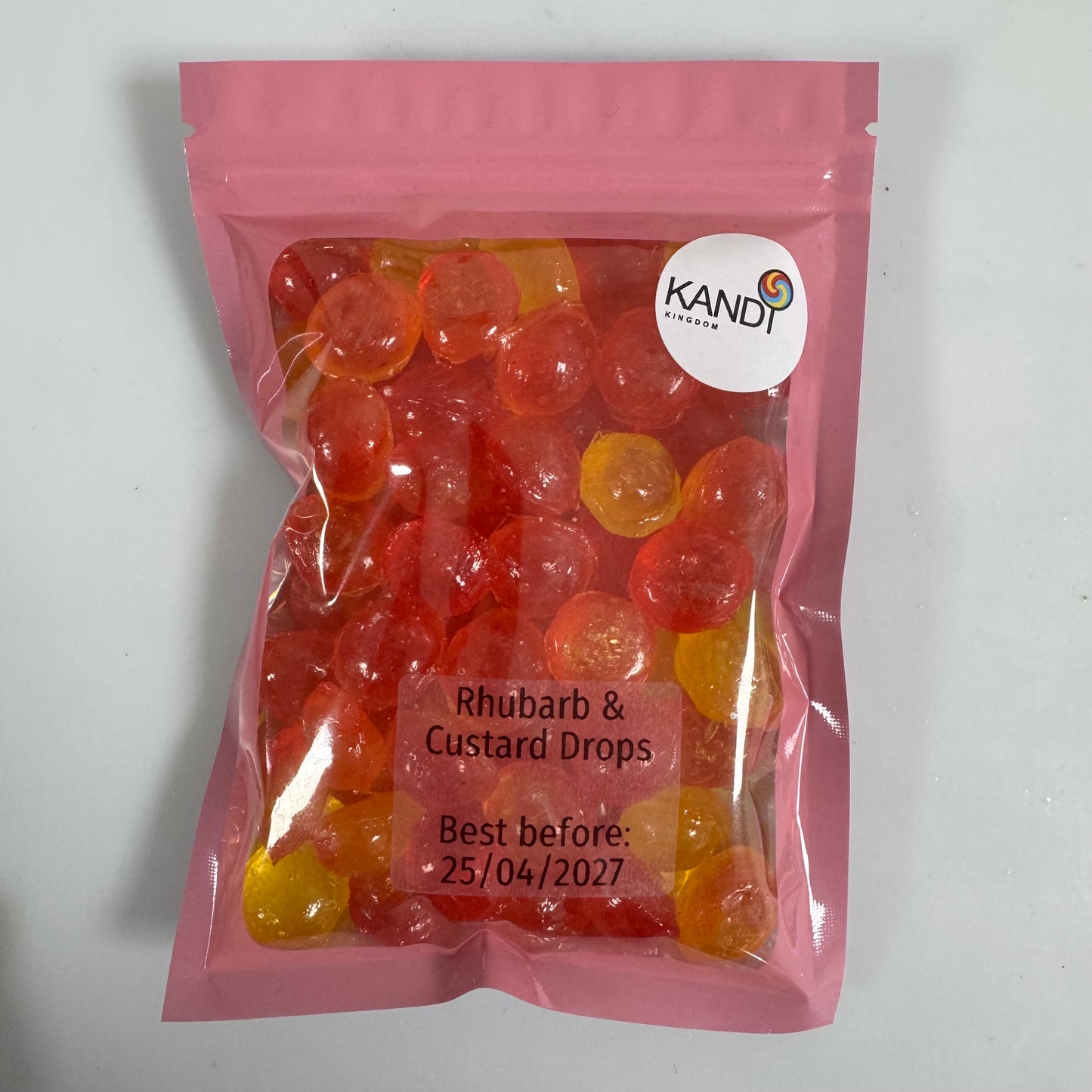 Pink package of Kandi Rhubarb & Custard Drops on a white background