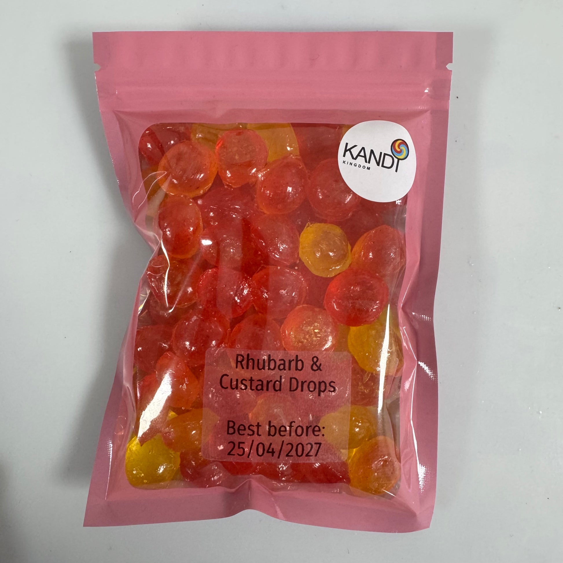 Pink package of Kandi Rhubarb & Custard Drops on a white background
