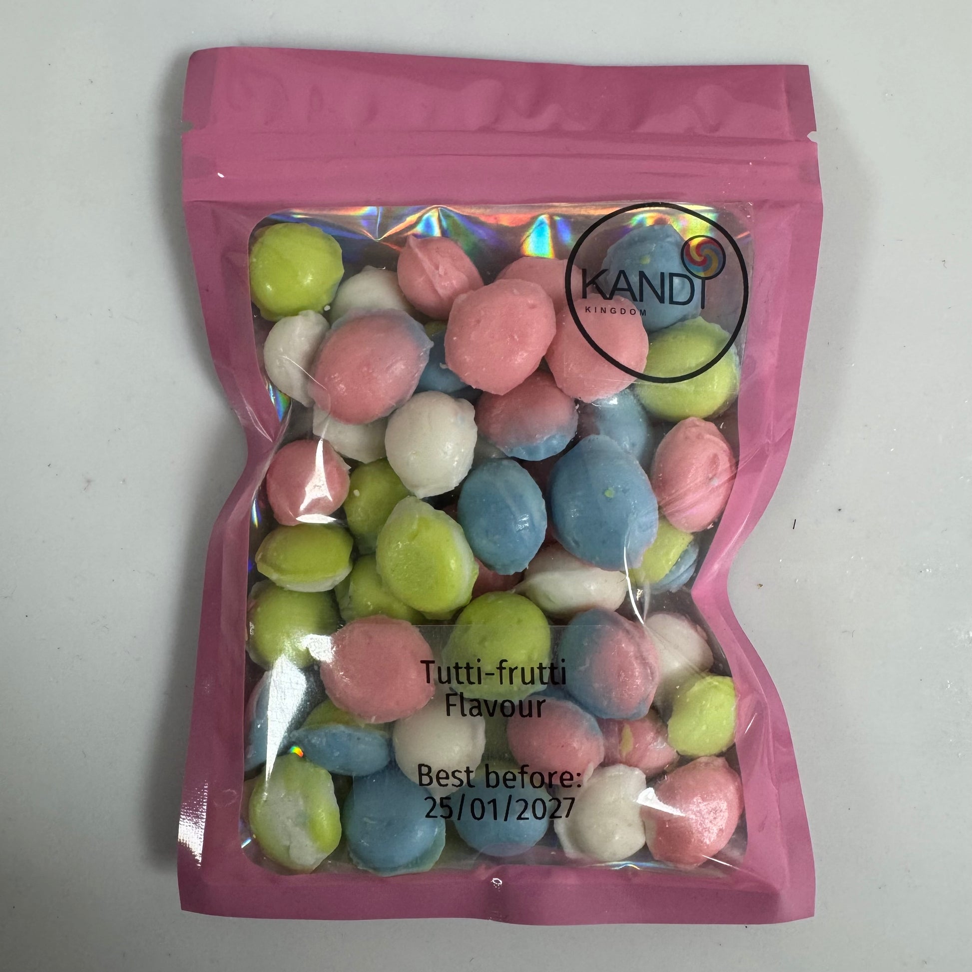 Pink bag of multicolored candies with 'Kandi' branding on a white background